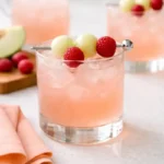 Close-up of a Fresh Raspberry Honey Deuce with honeydew melon balls and raspberries