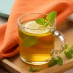 Served mug of lemon balm tea with lemon garnish for weight loss.
