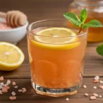 Glass of pink salt diet recipe detox water with lemon and honey