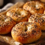 Freshly baked golden-brown bagels topped with everything seasoning from a homemade bagel recipe